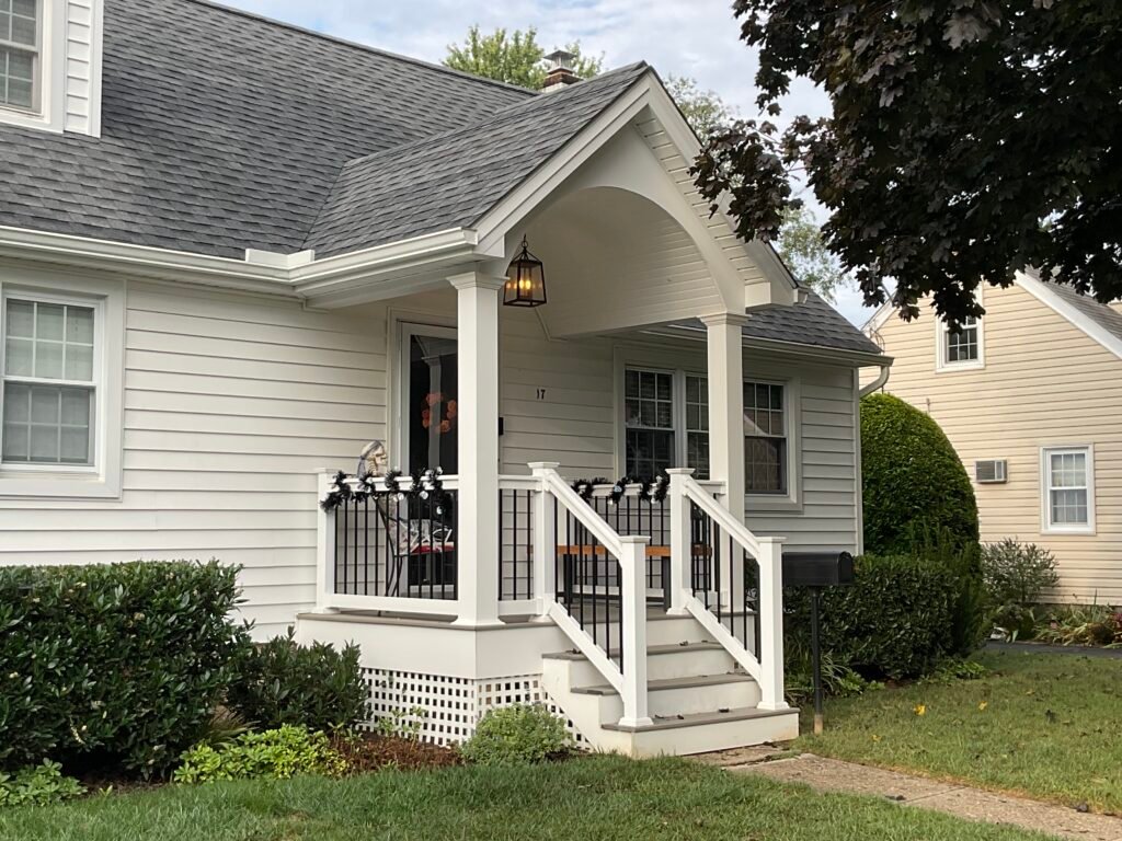 White home with new front porch - Skyline Exteriors - Skyline Exteriors White home with new front porch, columns and black railing