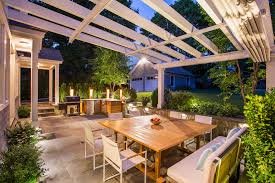 Pergola outdoor dining area at night - Skyline Exteriors - Skyline Exteriors Pergola-covered outdoor dining area at night