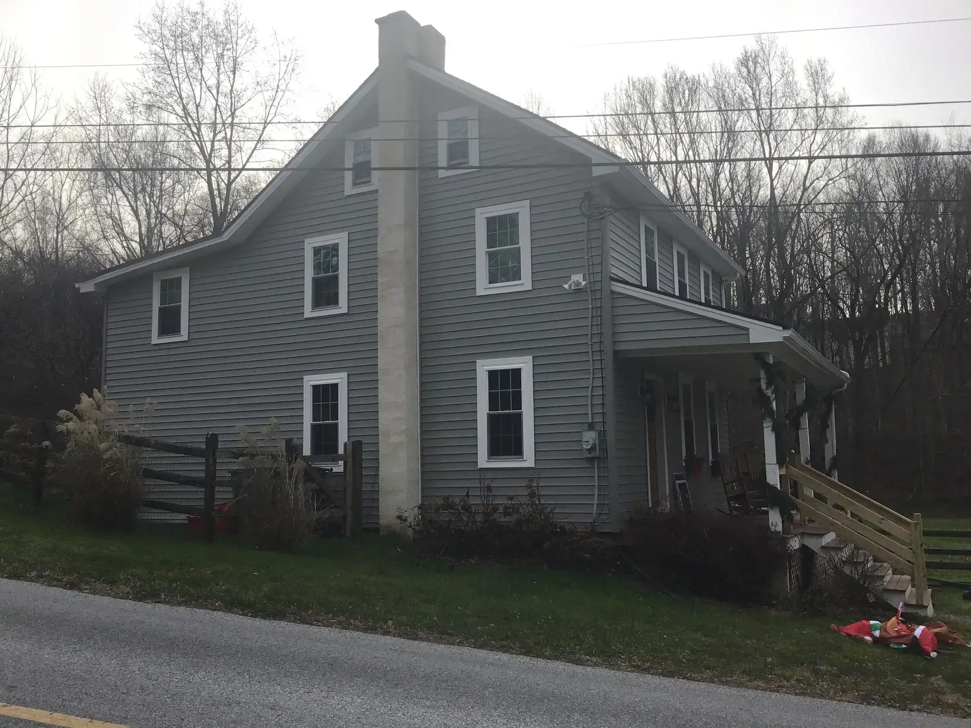 Gray stone farmhouse before exterior renovation