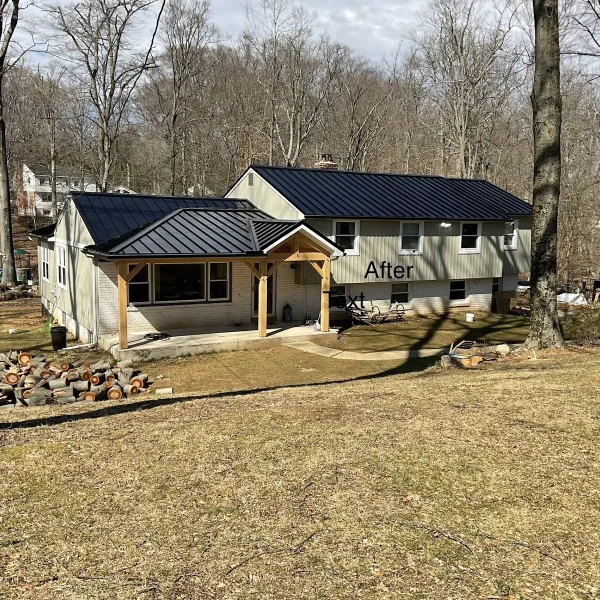 A home featuring a black metal roof and timber porch built by an exterior remodeler in St. Davids, PA.