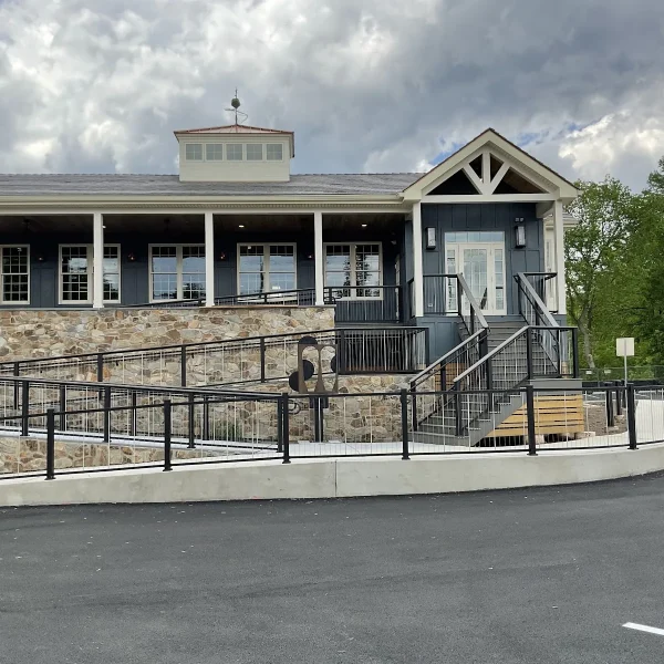 Dark blue siding and stone entry porch finished by an exterior remodeler in St. Davids, PA.