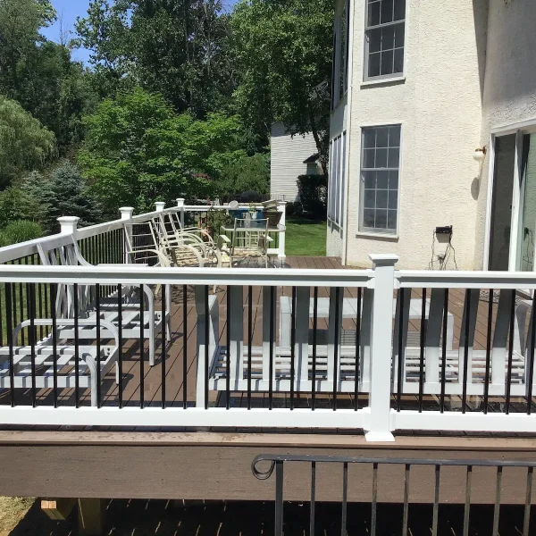 A spacious composite deck with white railings installed by an exterior remodeler in St. Davids, PA.