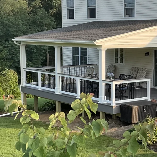 A covered composite deck built for a two-story home by an exterior remodeler in Radnor Township, PA.