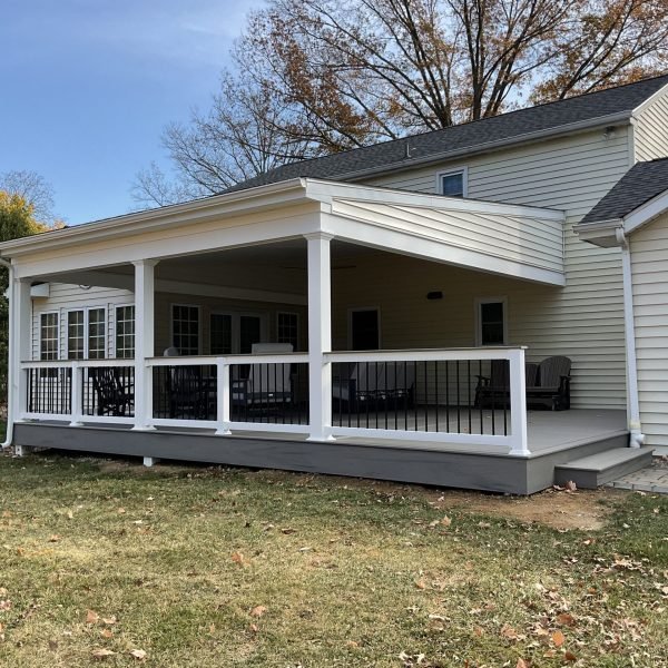 Beige home with new covered porch addition and composite deck