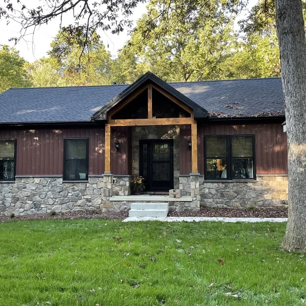 Dark vertical siding and stone veneer on a home updated by an exterior remodeler in Swarthmore, PA.