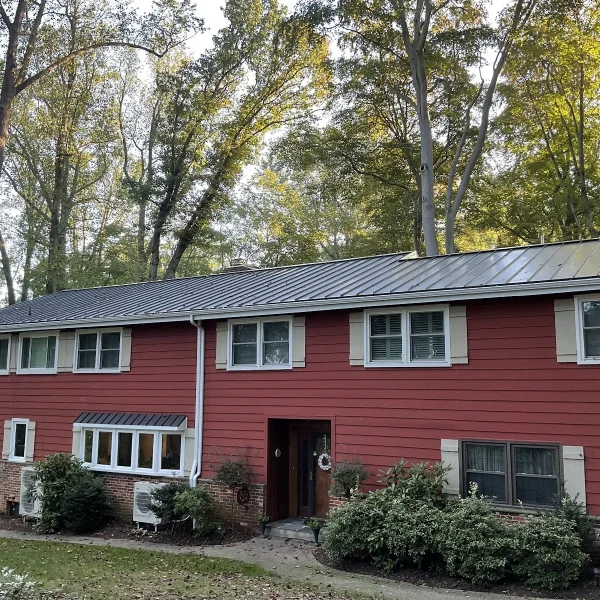 A red house with a metal roof updated by an exterior remodeler in Swarthmore, PA.